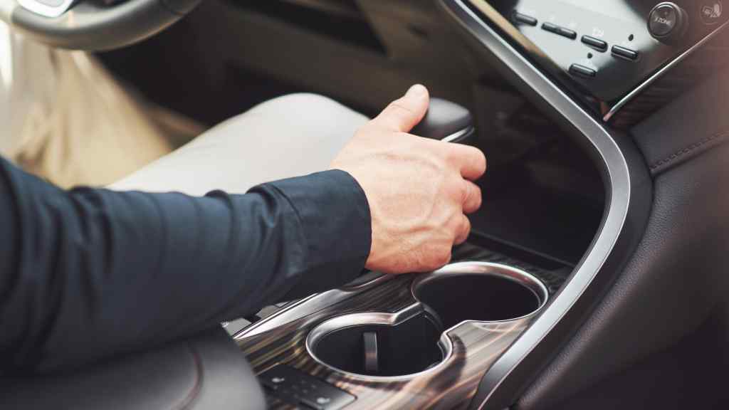 Hombre conduciendo un auto con transmisi&oacute;n autom&aacute;tica